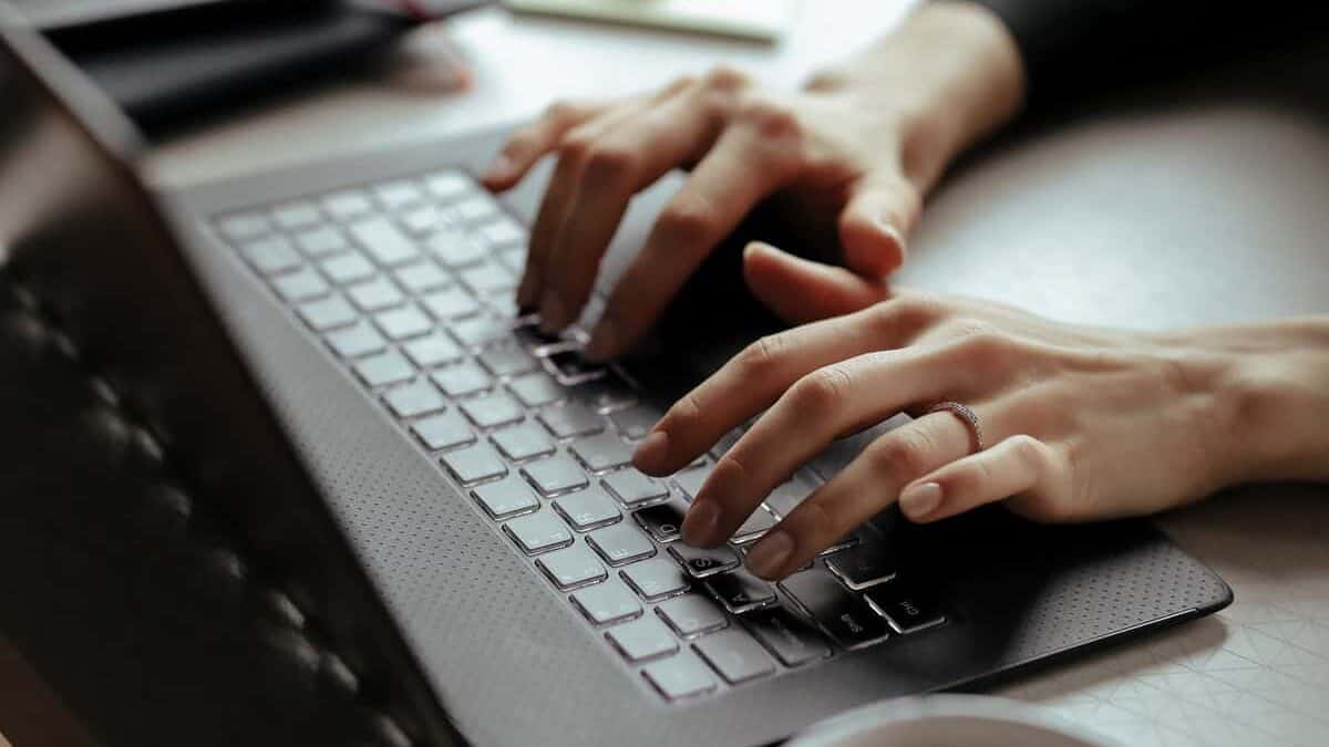 person typing on her computer